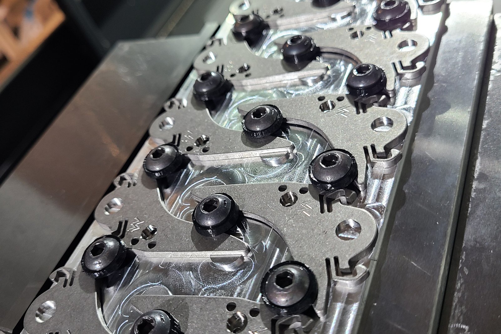 Custom fixture plate with toe-clamped parts on the mill table