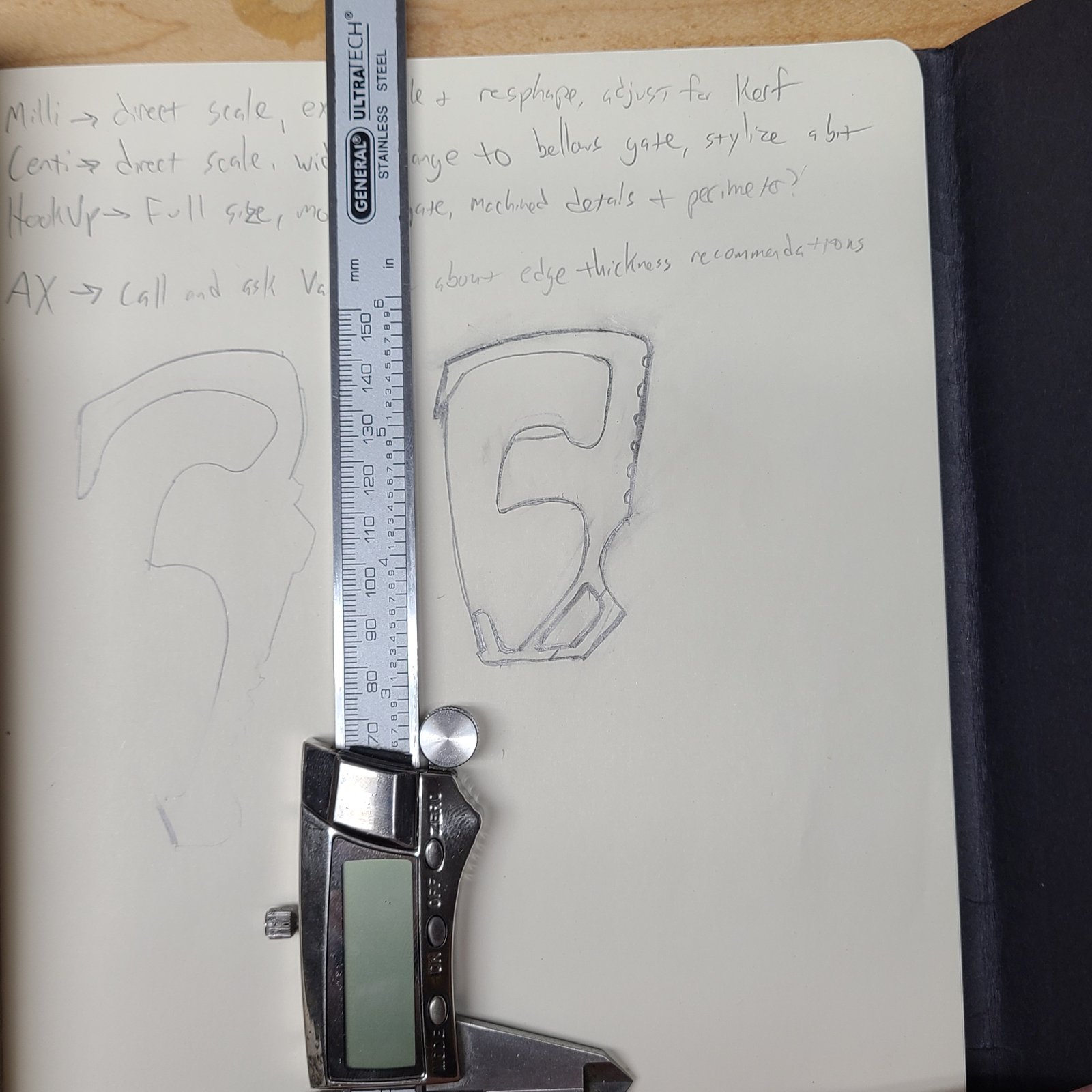 Notebook hand sketch of a carabiner with a caliper