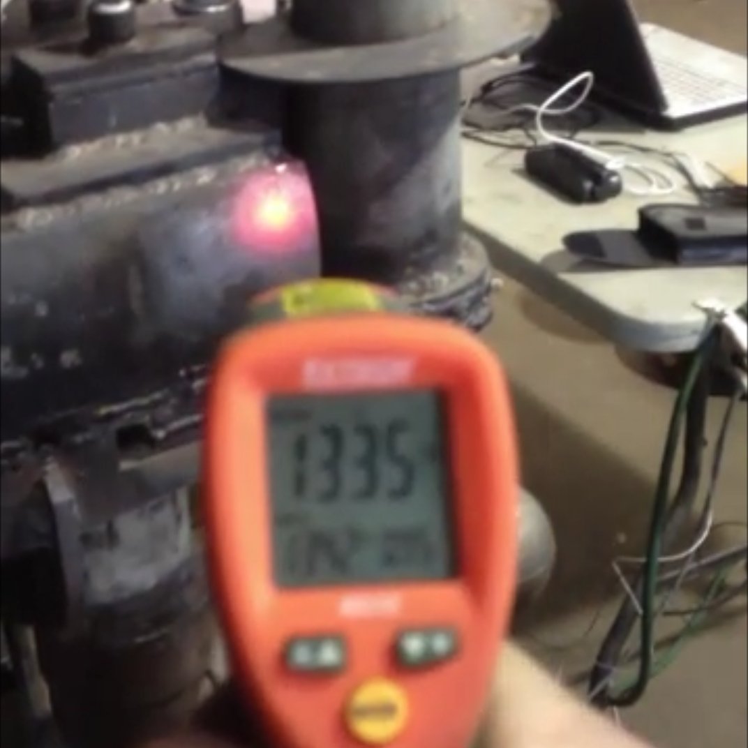 IR thermometer reading about 1335 °F on a prototype engine test rig